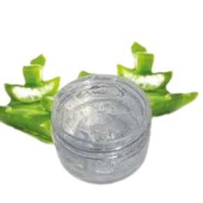 A clear glass jar filled with light green aloe vera gel, a natural skincare ingredient that moisturizes, soothes, and heals the skin. The jar is placed on a wooden table with a green slices of aloe vera plant next to it. The image conveys a sense of freshness, purity, and wellness. Elevate Your Skincare Creations at Organicsbyjumira skincare. Explore Now."